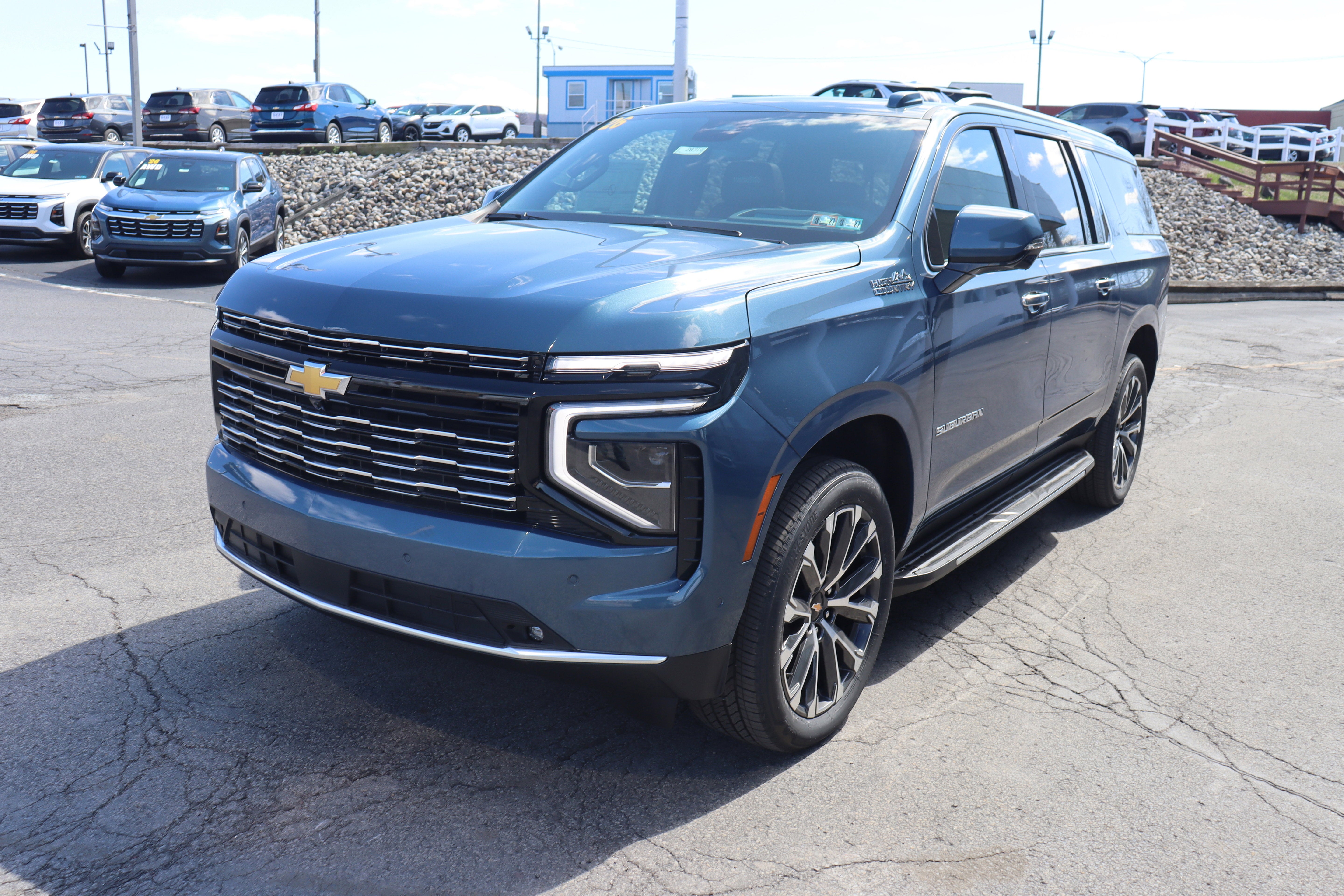 2026 Chevrolet Suburban High Country in Lakeshore Blue Metallic — front three-quarter view